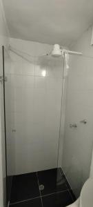 a shower with a glass door in a bathroom at Hotel Paradise Lleras in Medellín