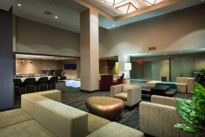 a lobby with couches and chairs and a bar at Hilton Cocoa Beach Oceanfront in Cocoa Beach