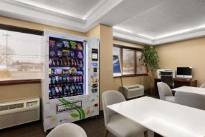 a vending machine in a restaurant with a table and chairs at Comfort Inn Bordentown near NJ Turnpike in Bordentown