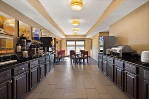 a large kitchen with a counter with a table at Comfort Inn Huntington Near University in Huntington