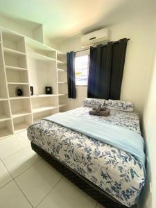 a bedroom with a bed with a teddy bear on it at Casa em Natal /Extremoz - RN in Extremóz