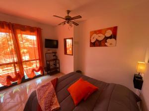 a bedroom with a bed and a ceiling fan at Camere Aeroporto Cagliari Elmas in Elmas