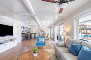 a living room with a couch and a table at Ocean Breeze I by AvantStay Steps to the Beach in Newport Beach