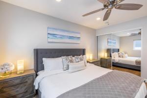 a bedroom with a bed and a ceiling fan at Ocean Breeze I by AvantStay Steps to the Beach in Newport Beach