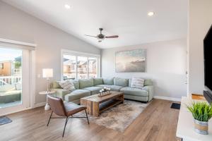 a living room with a couch and a table at Ocean Breeze II by AvantStay Steps to the Beach in Newport Beach
