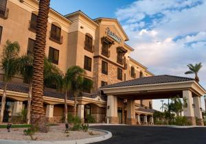 a hotel building with a palm tree in front of it at Radisson Hotel Yuma in Yuma