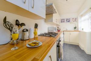 a kitchen with white cabinets and a wooden counter top at Liverpool City Haven-Dane Street in Liverpool