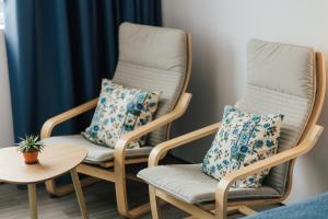 two rocking chairs with pillows in a room at Delightful Seaside Studio Apartment D - Faraway in Lagoa
