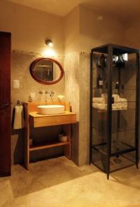 a bathroom with a sink and a mirror at La Pausa. Casa de campo in Deán Funes