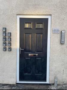 a black door on the side of a building at Garden of Eden 1 Bedroom Flat in Fishponds in Bristol