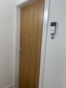 a wooden door in a hallway next to a room at Garden of Eden 1 Bedroom Flat in Fishponds in Bristol