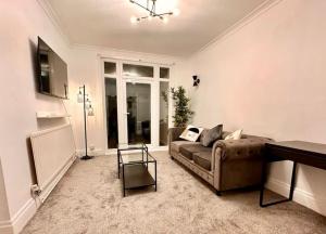 a living room with a couch and a table at Wembley wow house in Preston
