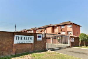 a sign on a fence in front of a building at 3The Olive Complex Richards Bay 3900 in Richards Bay