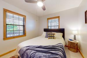 a bedroom with a bed and two windows at Skyridge in Blairsville