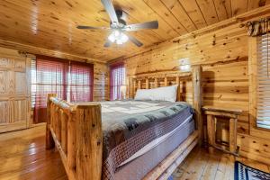 ein Schlafzimmer mit einem Bett in einem Blockhaus in der Unterkunft Endless Joy in Sevierville