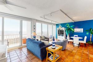 a living room with blue walls and a blue couch at Galvestonian 710 in Galveston