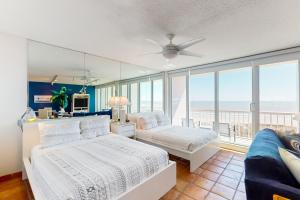 a bedroom with two beds and a view of the ocean at Galvestonian 710 in Galveston