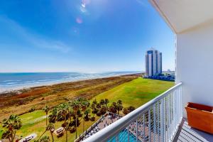 a balcony with a view of the beach and a building at Galvestonian 710 in Galveston