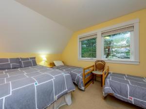 a bedroom with two beds and a window at Becalmed MCA#1653 in Manzanita