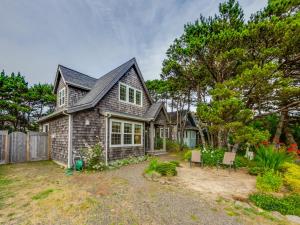 a house with a gray roof and a yard at Becalmed MCA#1653 in Manzanita