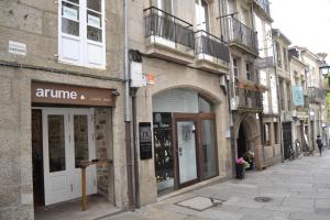 a street with an entrance to a store on a building at Apartamentos Turísticos Pacios in Santiago de Compostela