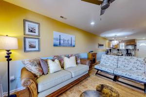 a living room with a couch and a table at The Palms --- 36507 Palm Dr #2102 in Rehoboth Beach
