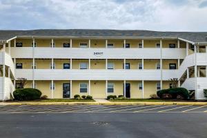 a large building with a parking lot in front of it at The Palms --- 36507 Palm Dr #2203 in Rehoboth Beach