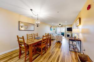 a dining room and living room with a table and chairs at The Palms --- 36507 Palm Dr #2203 in Rehoboth Beach