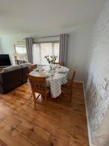 a dining table and chairs in a living room at Fair Green B&B in Ballygawley