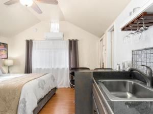 a kitchen with a sink and a bed in a room at Reno Studio Gem: Cozy Netflix Free Parking in Reno