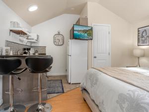 a bedroom with a bed and a sink and a refrigerator at Reno Studio Gem: Cozy Netflix Free Parking in Reno