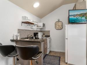a kitchen with a sink and a refrigerator at Reno Studio Gem: Cozy Netflix Free Parking in Reno