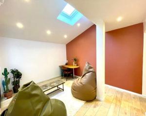 a living room with a couch and a table at maison avec spa et salle de projection in Cournonterral