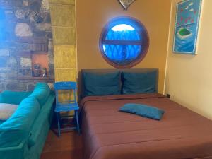 a living room with a couch and a window at Loft Sul Mare in Balestrate +12 photos