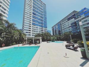 a large swimming pool in a city with tall buildings at Departamento en Puerto Madero in Buenos Aires