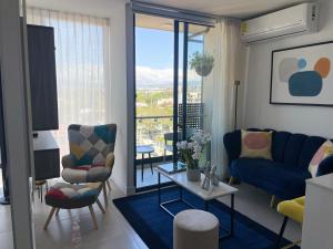 a living room with a blue couch and chairs at SkyGarden Nunciatura Luxury Apartment in San José