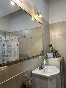 a bathroom with a sink and a mirror at Casa Q. in Córdoba