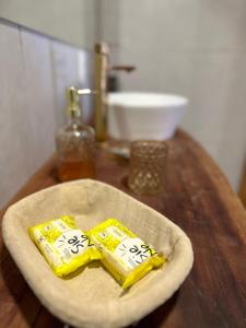 two packets of butter sitting on a plate on a table at Pousada Beach House Coqueirinho in Jacumã