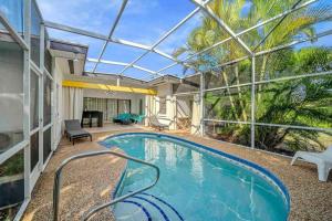 an indoor swimming pool with a glass roof at Fantastic Island House 1 mile to the beach with heated pool in Sarasota