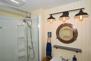 a bathroom with a shower and a sink and a mirror at L'Ancre de Matane in Matane