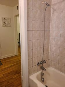 a bath tub with a shower in a bathroom at 425$ 7nights // Full Kitchen // Room B in Montréal