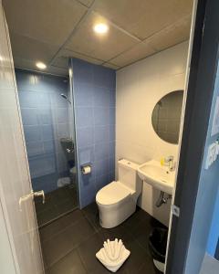 a bathroom with a toilet and a sink at Siri Hotel Phuket in Phuket Town