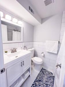 a white bathroom with a sink and a toilet at Cozy Getaway Lodge & Retreat in Mechanicsburg
