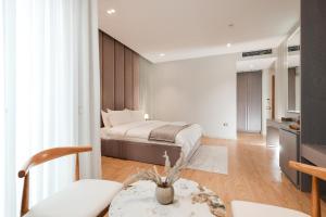a bedroom with a bed and a living room at Troci Hotel in Tirana