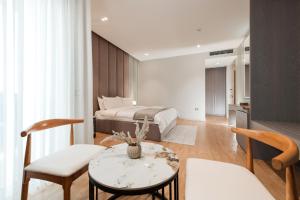 a bedroom with a bed and a table and chairs at Troci Hotel in Tirana