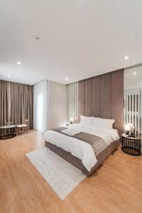 a large bedroom with a large bed and wooden floors at Troci Hotel in Tirana