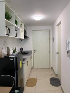 a kitchen with a white door and a white counter at BRENT CONDO UNIT WITH FREE PARKING & NETFLIX in Tagaytay