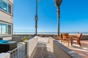 a balcony with two chairs and a view of the beach at 101-luxury1 in San Diego