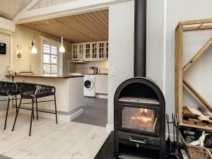 a kitchen and living room with a fireplace at 8 person holiday home in R dby in Rødby