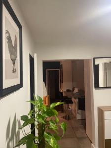 a living room with a picture of a chicken on the wall at Cosy Colour Place in Villiers-sur-Marne